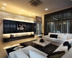 a modern living room with white furniture and black accents