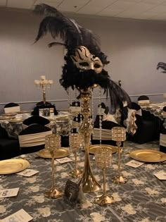 a fancy table setting with black and gold decorations