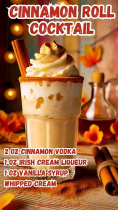 the cinnamon roll cocktail is served in a tall glass with whipped cream and cinnamon sticks