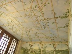 the ceiling is painted with vines and leaves