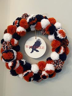 a wreath is hanging on the wall with an eagle ornament attached to it