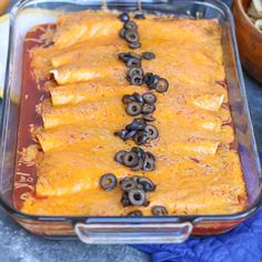 a casserole dish with black olives and cheese