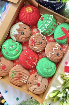 a box filled with decorated cookies on top of a table