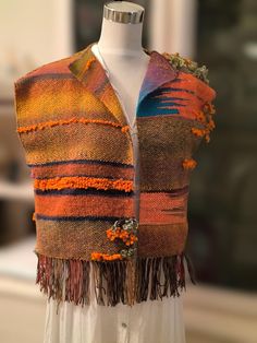 One of a kind /handwoven , Vest. Beautiful Autum colors ,green, orangean and a little blue ,simple design with texture which can be worn all day! Special piece of clothing. Handwoven and slowmade with Love and one of a kind.  A Vest made with wool.,cotton and funsy yarns ,in Saori free style weaving.  Good for a  SMALL size A very beautifu handwoven pin is a GIFT for you to decorate your vest,or any other cloth. Very soft to the touch, You will get the woven pin as a GIFT to decorate your vest, Designer Shawl, Shawl Pin, Shawl Pins, Fibre Art, Whimsical Fashion, Cropped Tube Top, Free Style, Colors Green, Weaving Patterns