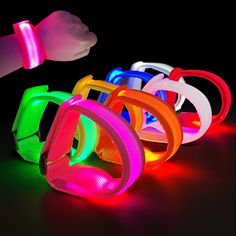 an image of glow bracelets in the dark with light up wristbands on