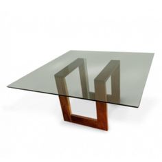 a glass table with wooden legs and an unusual design on the top, against a white background