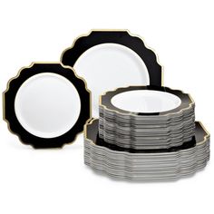 a stack of black and white plates with gold trimmings on the edges, sitting next to each other