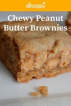 two pieces of peanut butter brownies sitting on top of a white plate with the words, allrecipes chewy peanut butter brownies