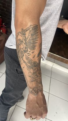 a man with a bird tattoo on his arm