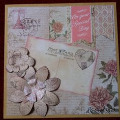 a close up of a greeting card with flowers and hearts on the front, surrounded by other cards