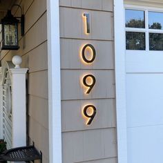 a house that has some lights on the side of it and there is a door in front of it