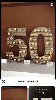 the number 50 made out of cupcakes is displayed in front of other items