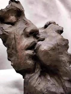 a sculpture of a man's head with his eyes closed