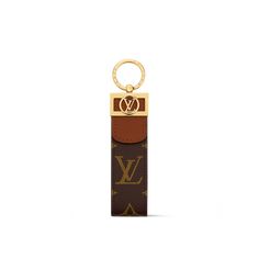 a keychain with a louis vuitton logo on the front and side