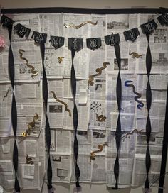 A photo backdrop is taped to a wall. It consists of pieces of layered black and white newspaper adorned with golden paper snakes. Across the top of the wall, a black banner reads "Reputation" in the font used on Taylor Swift's Reputation album. Black twisted streamers emerge from behind the letters, reaching to the bottom of the newspaper. Taylor Swift Reputation Bachelorette, Taylor Swift Birthday Party Reputation, Taylor Swift Birthday Reputation, Reputation Taylor Swift Themed Party, Taylor Swift Reputation Bachelorette Party, Taylor Swift Themed Birthday Party Reputation, Reputation Taylor Swift Party Theme, Taylor Swift Reputation Party Ideas, Taylor Swift Inspired Cake Reputation