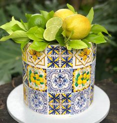 a cake decorated with lemons and green leaves