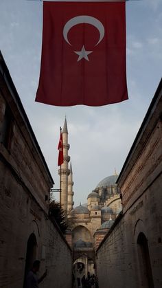 a turkey flag flying in the air over an alley way