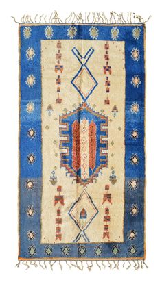 an old rug with blue and white designs on it's sides, fringes around the edges