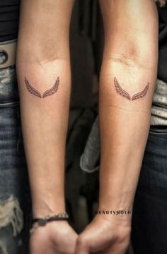 two people with matching tattoos on their arms