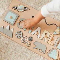 a child playing with wooden letters and magnets