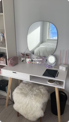 a white desk with a mirror, stool and other items sitting on top of it