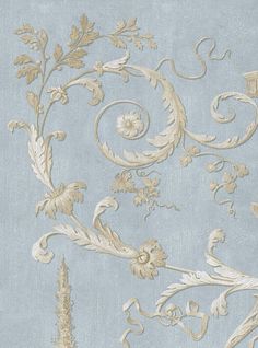 a blue and gold wallpaper with various designs on it's side, including flowers