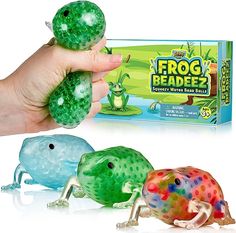 the frog beadedz toy is being held up by a person's hand