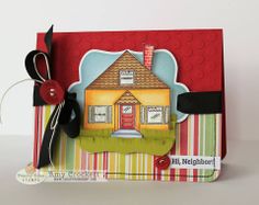 a close up of a card with a house on the front and a ribbon attached to it