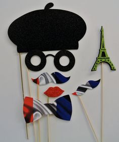 a cake topper made to look like a man in a hat and glasses with the eiffel tower in the background