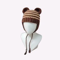 a knitted hat with ears on top of a mannequin's head