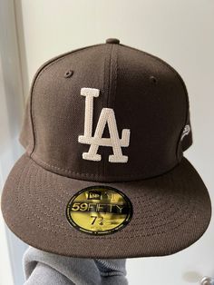 *NEW/NEVER WORN* I bought this hat not knowing the correct size for myself. So this hat has never been worn.  Size: 7 3/4 Color: Walnut Brown The emblem is a woven stick that looks so unique.  This is the perfect hat for any Dodgers fan!  Comes from a smoke-free home.  Please feel free to reach out with any questions! ALL SALES ARE FINAL Brown Fitted Hat With Flat Bill, Brown Flat Brim Baseball Cap, One Size Fits Most, Brown Flat Brim Baseball Cap One Size, Casual Short Brim Hat For Baseball Season, Brown Flat Brim Hat With Embroidered Logo, Brown Baseball Cap With Embroidered Logo, Brown Snapback Hat With Embroidered Logo And Flat Brim, Brown Flat Brim Snapback Hat With Embroidered Logo, Brown Adjustable Hat With Embroidered Logo