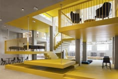 a room with yellow stairs and chairs in the center, next to a staircase that leads up to an upper floor