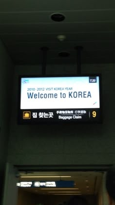 a welcome to korea sign hanging from the ceiling