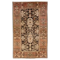 an antique persian rug with various colors and designs on the border, including black, brown, beige, orange