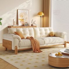 a living room with a couch, coffee table and potted plant in the corner