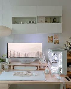 a computer monitor sitting on top of a desk next to a keyboard and mouse pad