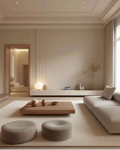 a modern living room with white walls and beige carpeted flooring, two round ottomans on the coffee table