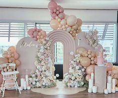 a room decorated with balloons and flowers