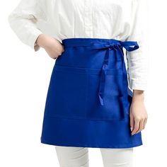 a woman wearing a blue apron and white shirt