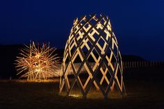 fireworks are lit up in the night sky near a structure that is shaped like a star