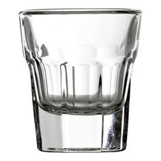 an empty shot glass on a white background