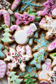 many decorated christmas cookies on a table