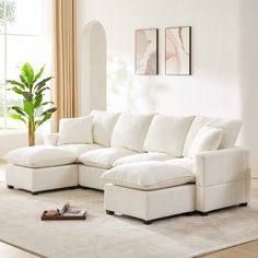 a living room with a large white sectional couch