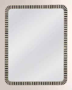 a square mirror with black and white stripes