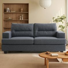 a living room scene with focus on the couch and coffee table in the foreground