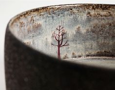 a bowl with a tree painted on it