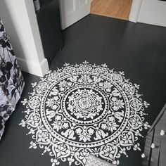 a black and white floor with an intricate design on it