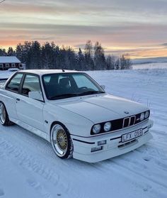 a white car is parked in the snow