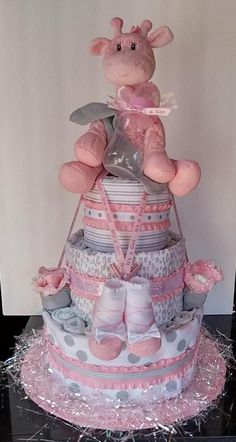 a baby shower cake with a giraffe sitting on top of it's diaper