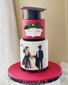 a three tiered cake decorated with an image of two people in graduation caps and gowns